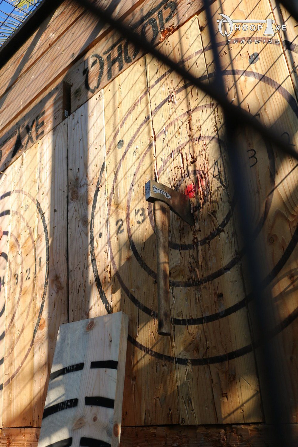 Axe stuck in a wooden bullseye target